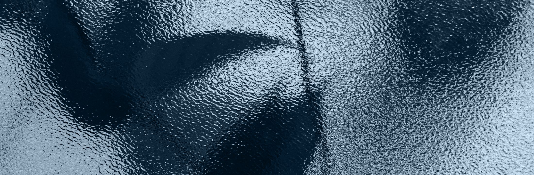 Textured blue-grey surface with rippled patterns.