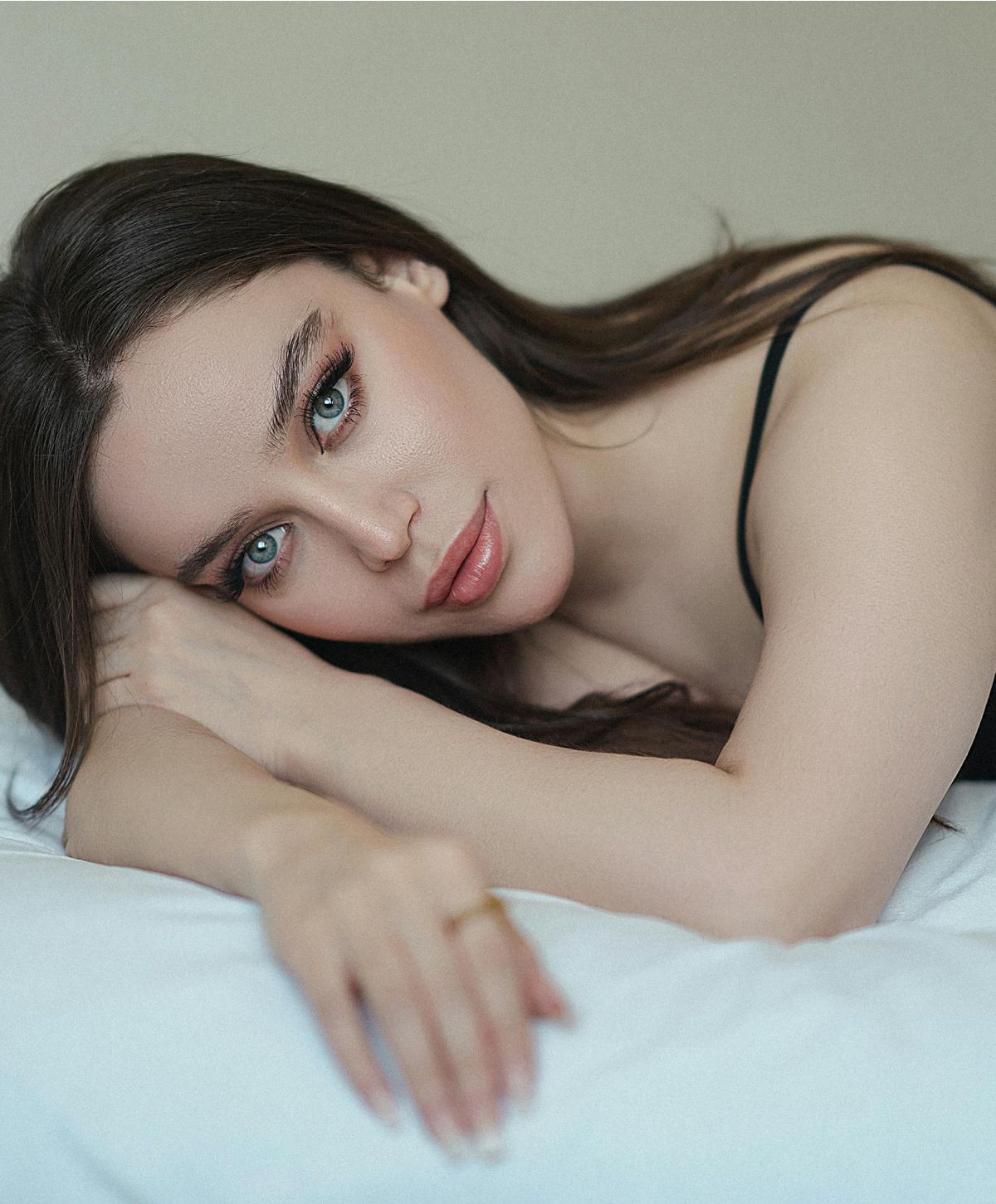 Close-up portrait of a woman lying down.