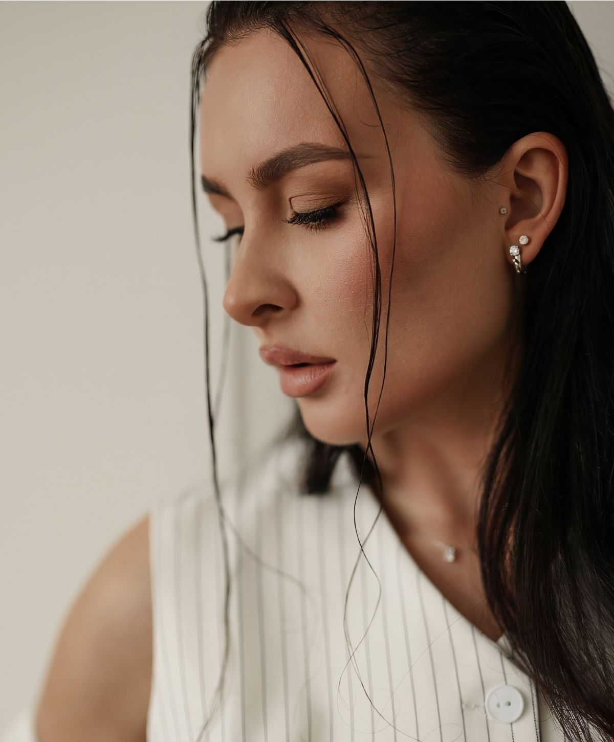 Profile of a woman with elegant hairstyle and makeup.
