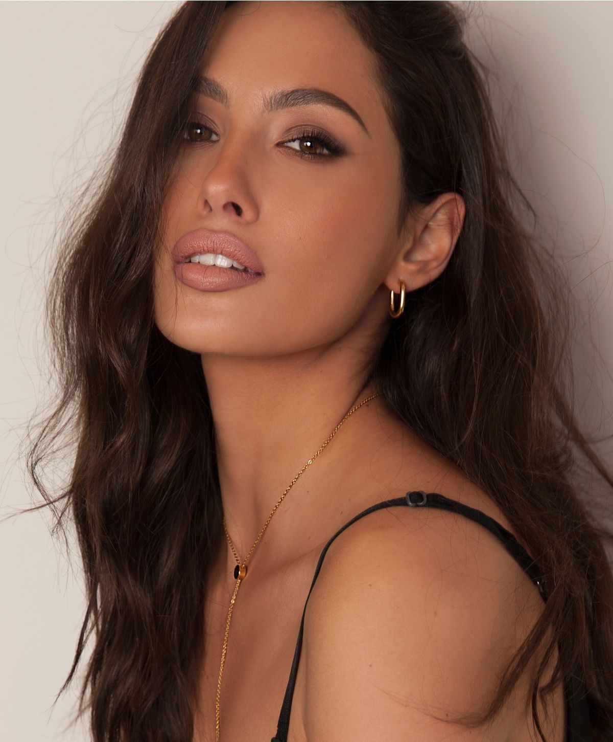 Close-up portrait of a woman with wavy hair.