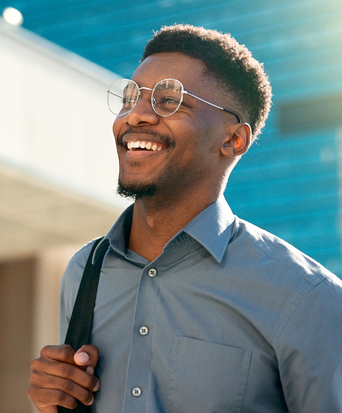 Man in suit looking thoughtful outdoors.