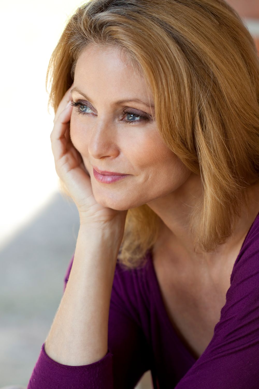 Woman with short blonde hair and blue eyes.