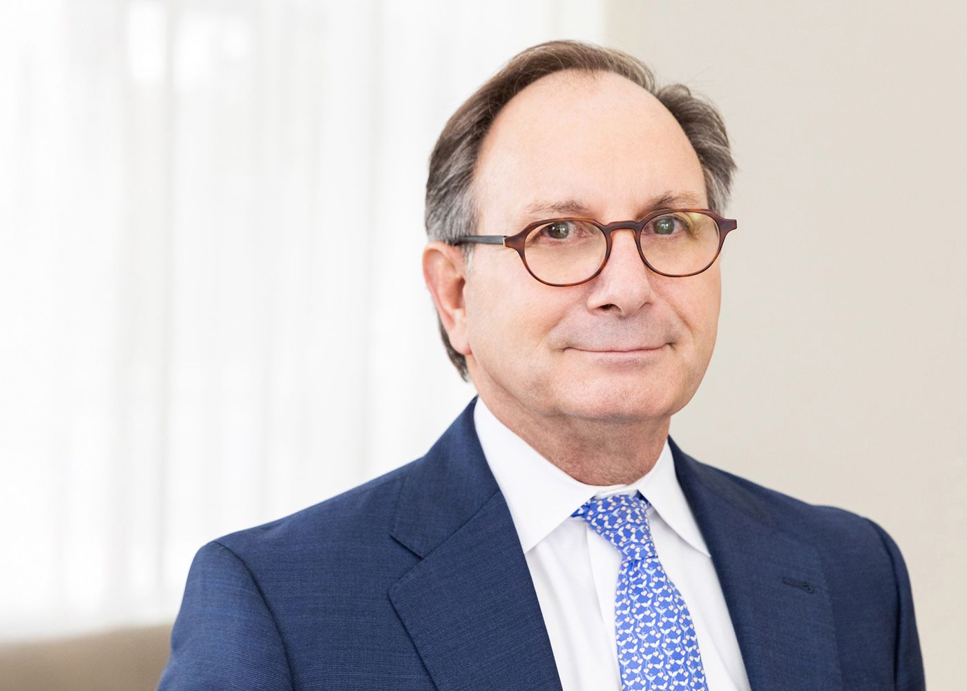 Business professional in suit with glasses.