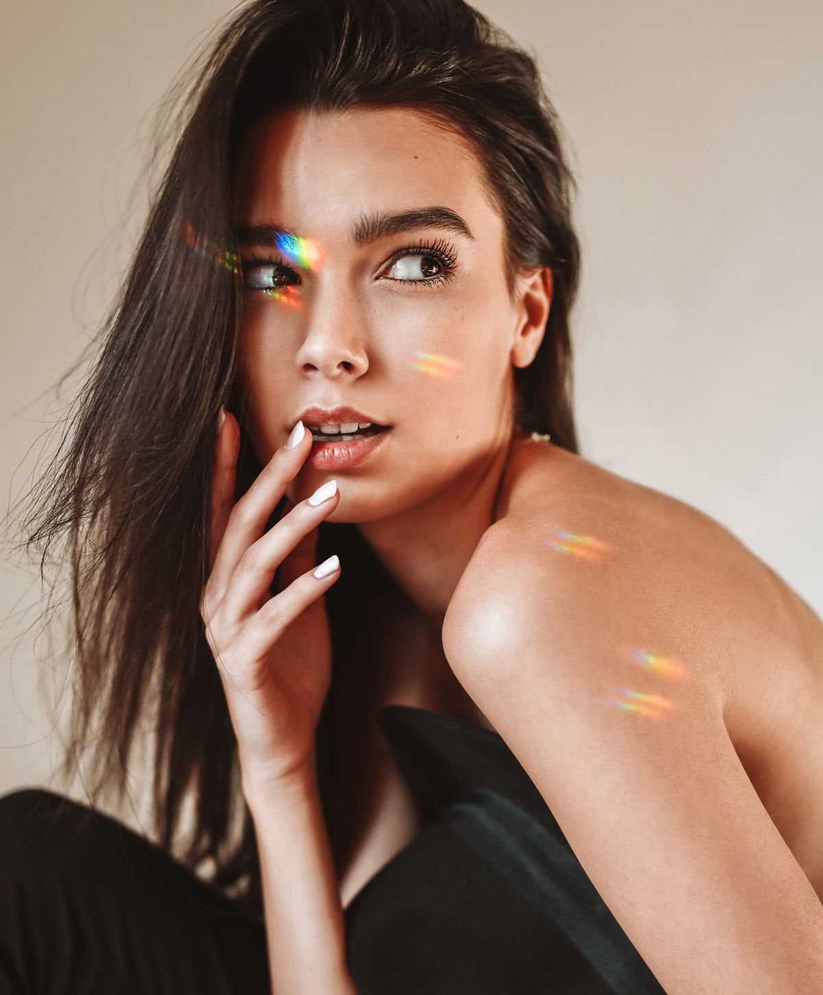 Portrait of a woman with rainbow light reflections.