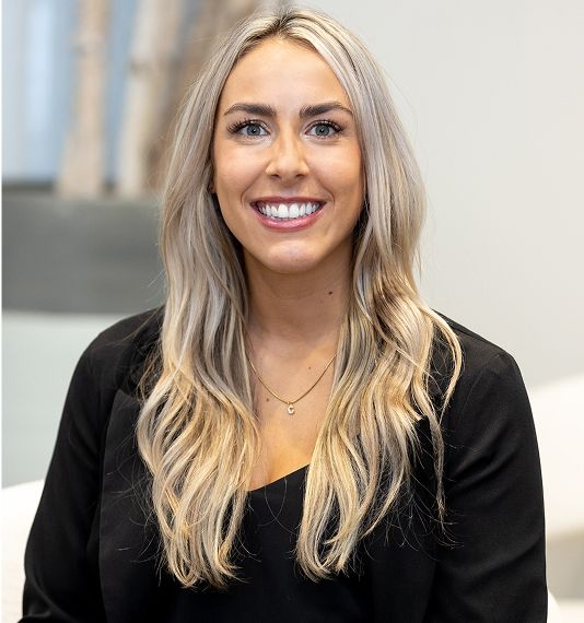 Smiling woman with long blonde hair in black top