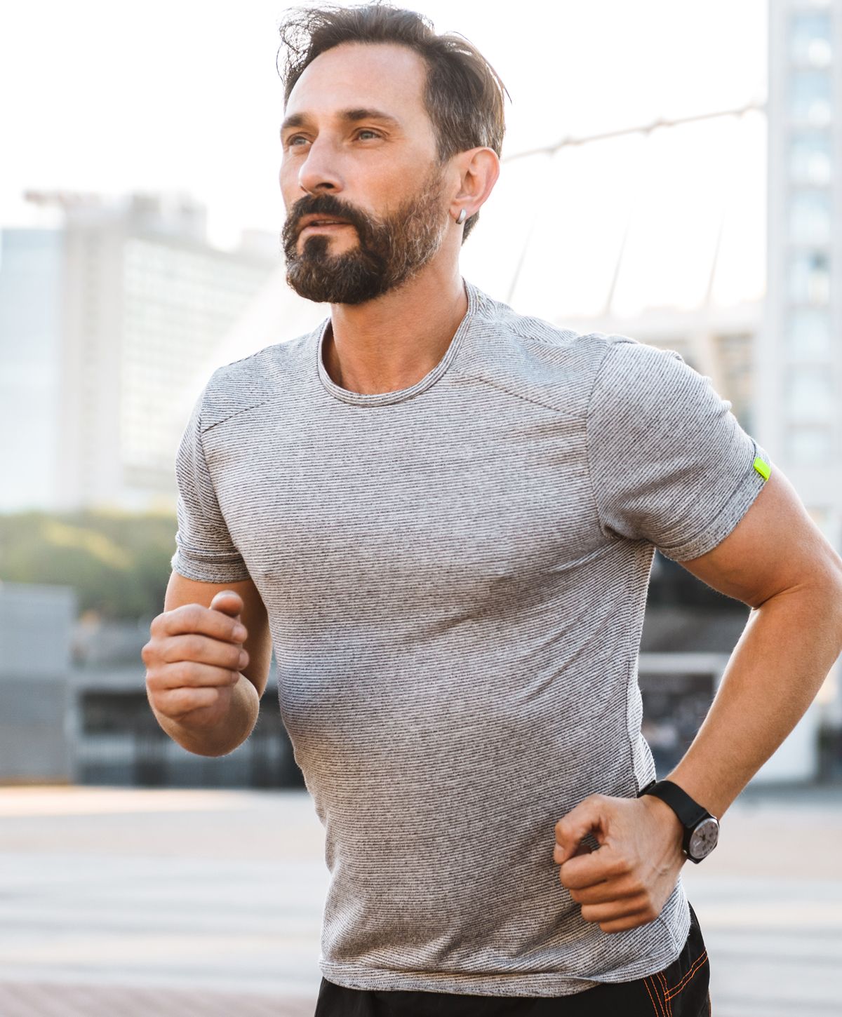 Man running outdoors in athletic clothing.