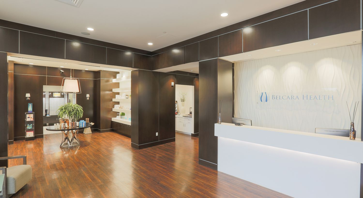 Modern health clinic reception area with wood flooring.